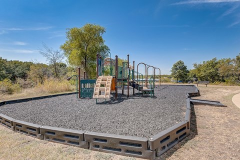 A playground in a park with a blue sky in the background at The Legends at Eagle Mountain Lake, Texas, 76179